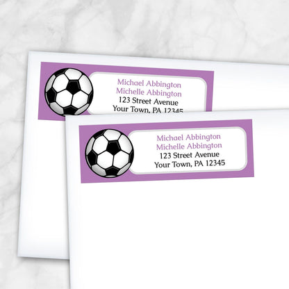 2 Purple Soccer Ball Return Address Labels shown on white envelopes on a marble surface