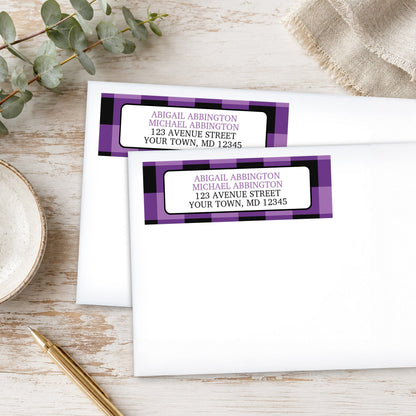 Purple and Black Buffalo Plaid Address Labels on white envelopes, shown on a wooden surface with plants and a pen.