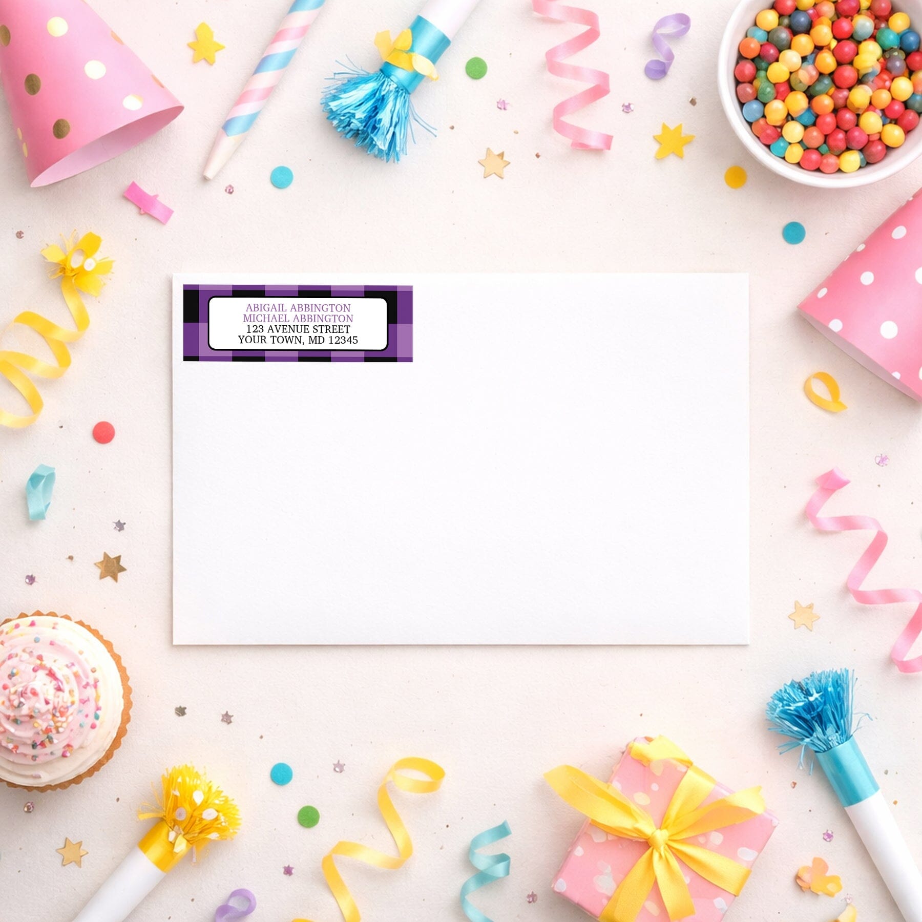 Purple and Black Buffalo Plaid Address Label shown on a white envelope with party supplies