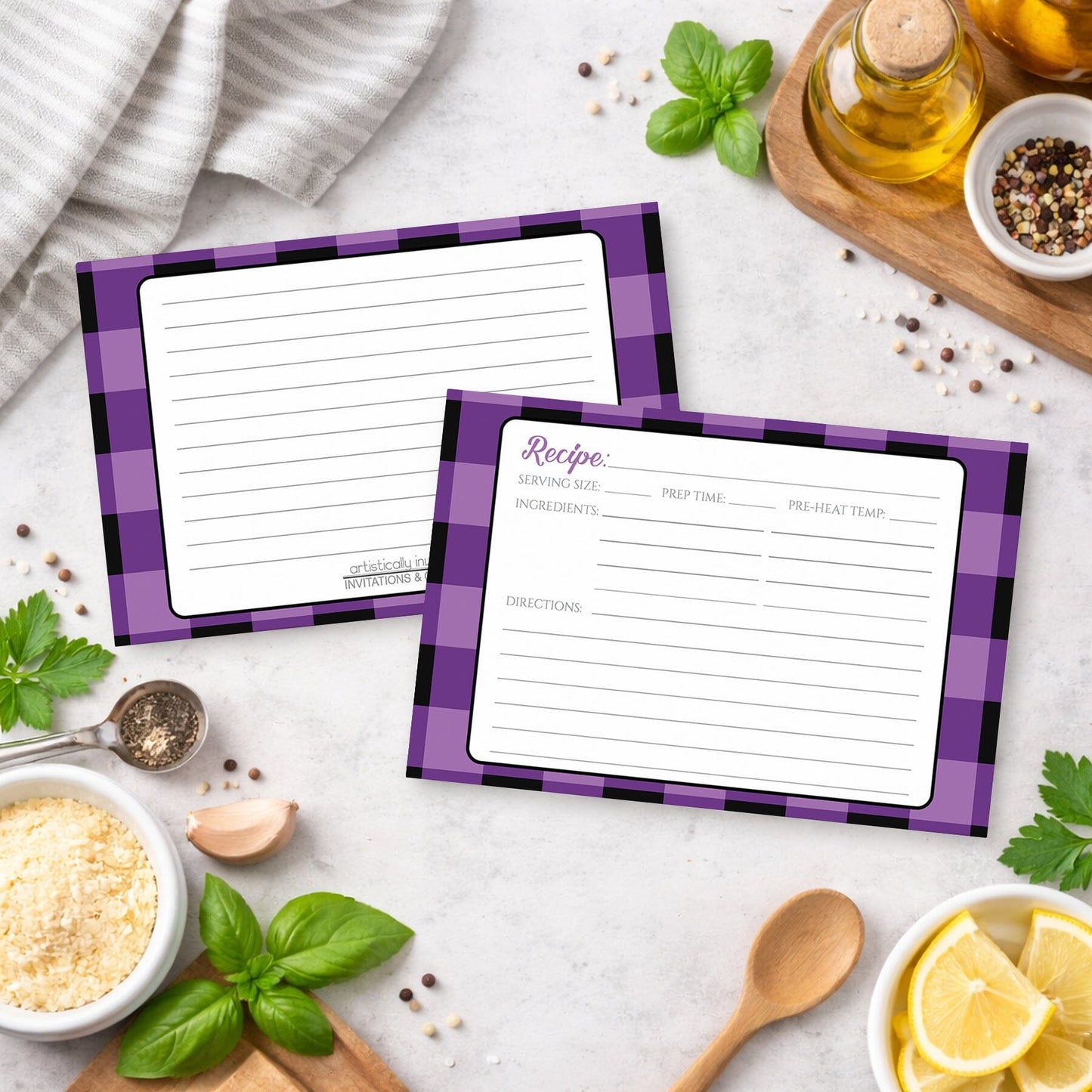 Two Purple and Black Buffalo Plaid Recipe Cards with purple checkered borders on a kitchen counter with ingredients.