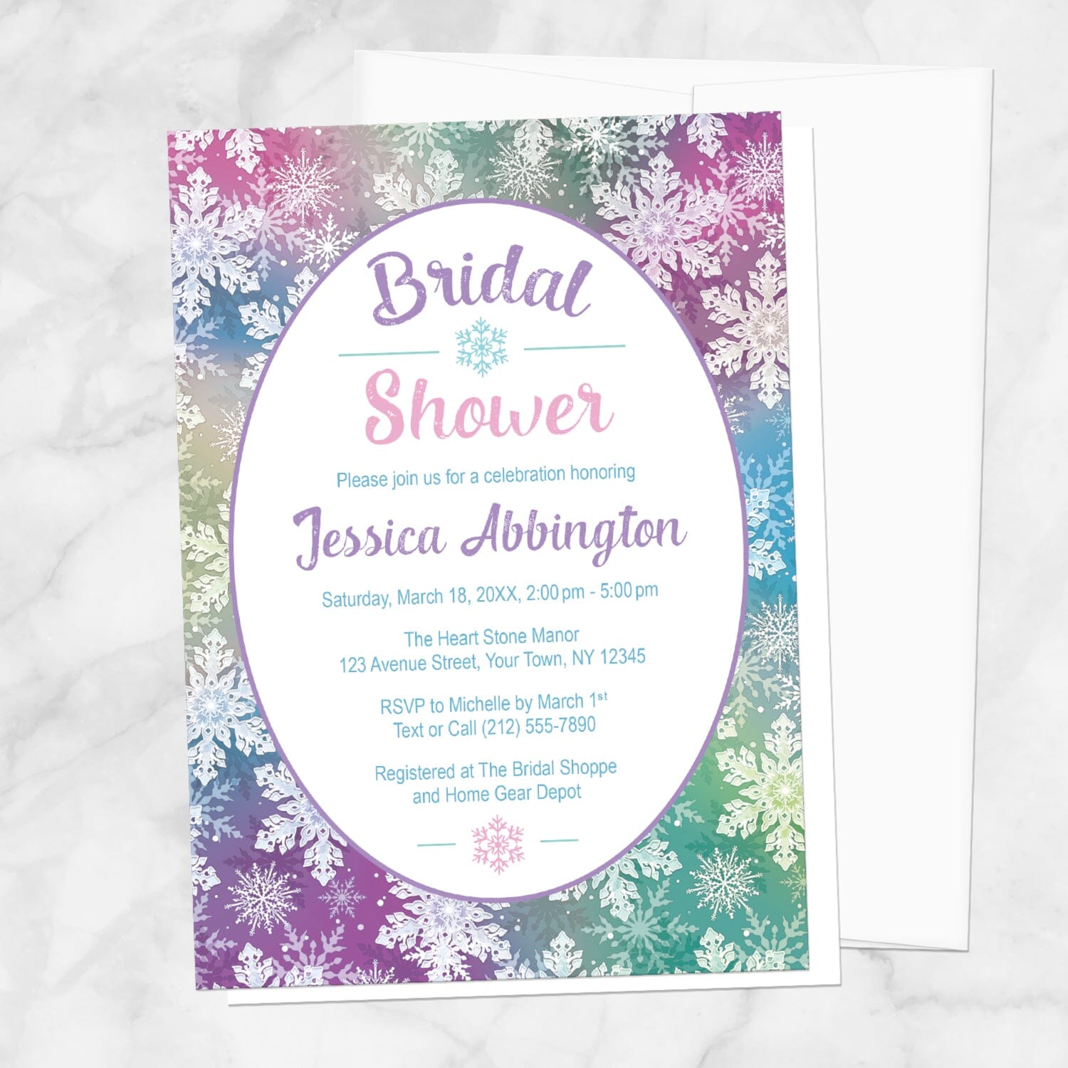 Rainbow Snowflake Bridal Shower Invitation shown on a marble surface with a white envelope.