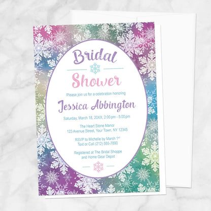 Rainbow Snowflake Bridal Shower Invitation shown on a marble surface with a white envelope.