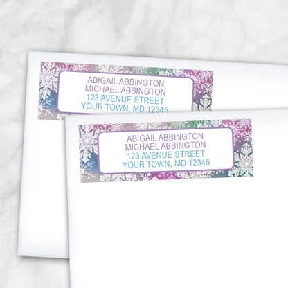 2 Rainbow Snowflake Winter Return Address Labels shown on white envelopes on a marble surface