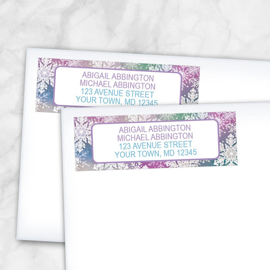 2 Rainbow Snowflake Winter Return Address Labels shown on white envelopes on a marble surface