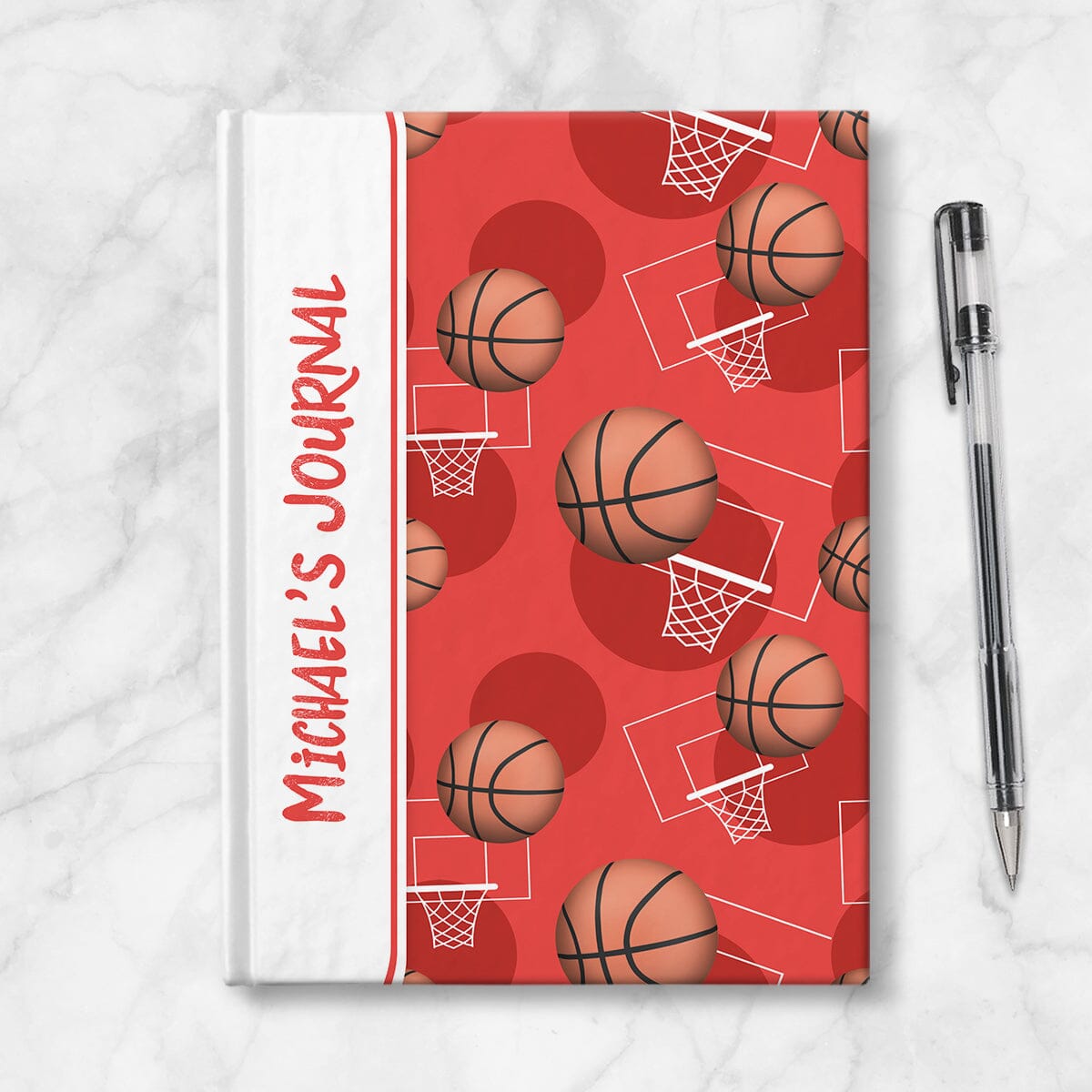 Personalized Red Basketball Journal at Artistically Invited. Image shows the book on a countertop next to a pen.