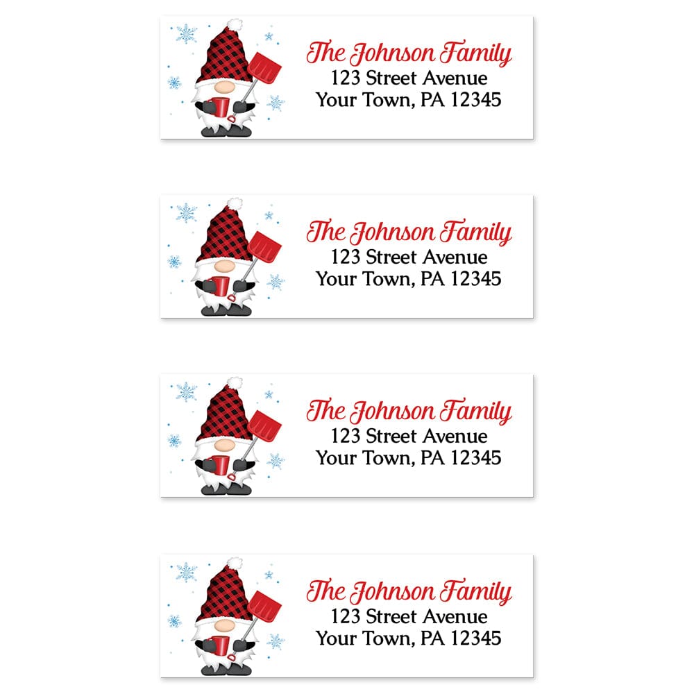 Red Buffalo Plaid Gnome Address Labels at Artistically Invited. Sheet of 4 labels. These address labels are designed with an illustration of a cute gnome wearing a red buffalo plaid hat while holding a red snow shovel and a hot beverage with snowflakes around him. Your personalized return address is custom printed in red and black over white to the right of the winter-themed gnome.