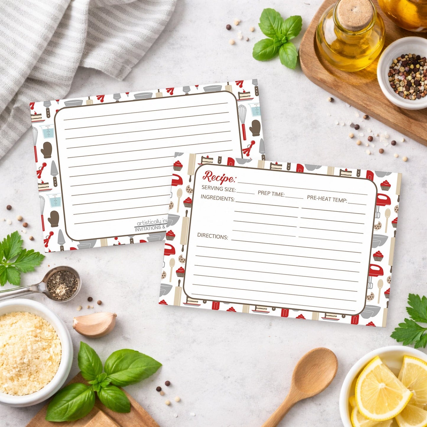 Two Red Baking Pattern Recipe Cards on a kitchen counter with everyday cooking ingredients and utensils.