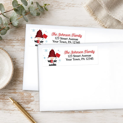 Red Buffalo Plaid Gnome Address Labels on white envelopes, shown on a wooden surface with eucalyptus leaves and a pen.