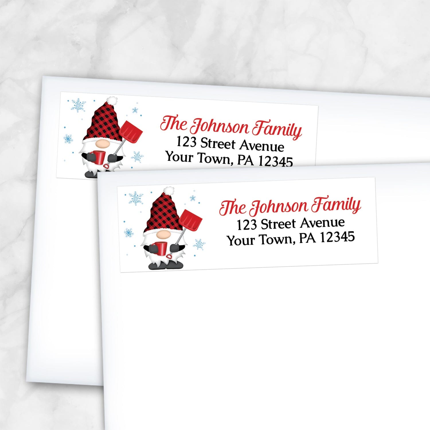 2 Red Buffalo Plaid Gnome Address Labels shown on white envelopes on a marble surface