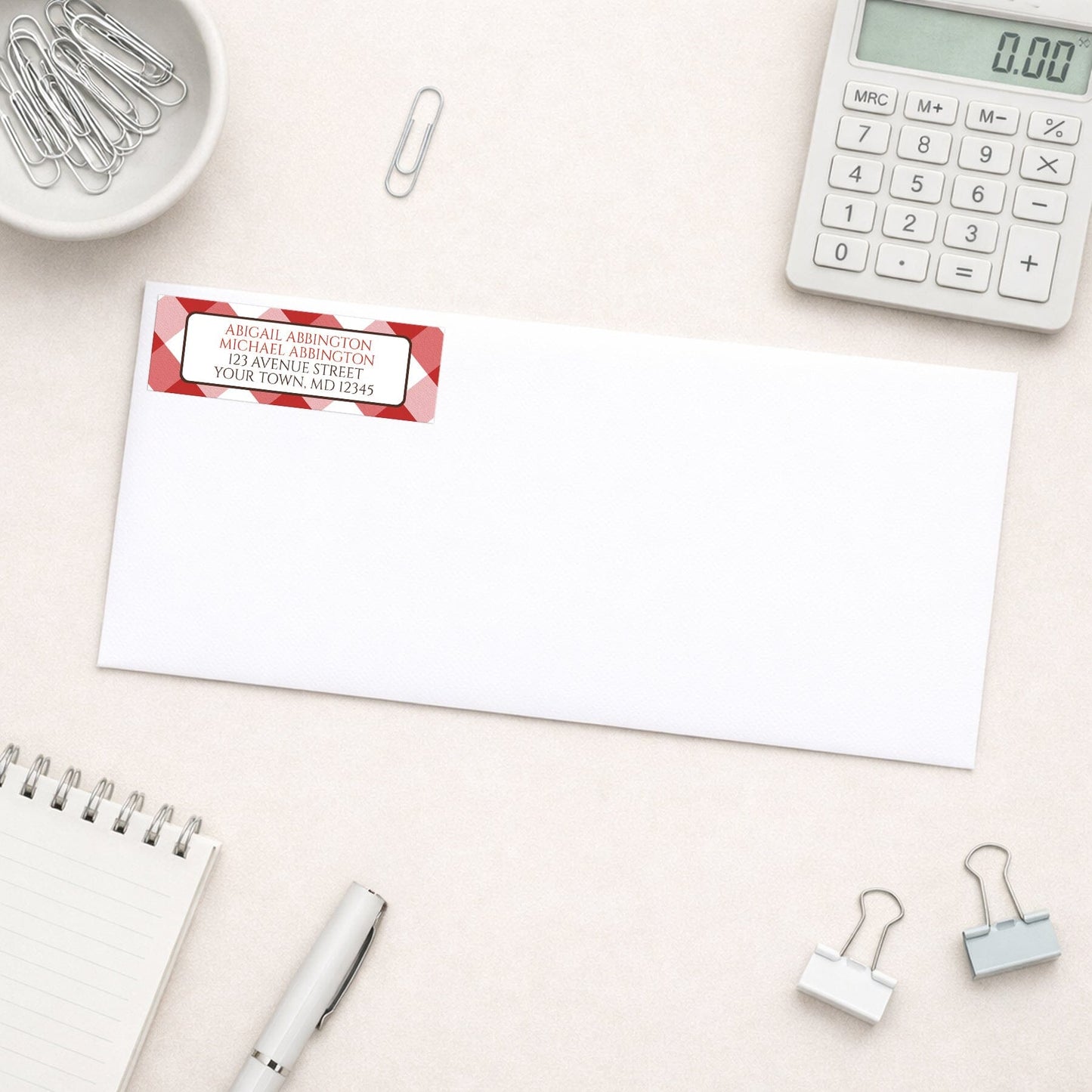 Red Gingham Address Label shown on a white envelope with everyday office supplies
