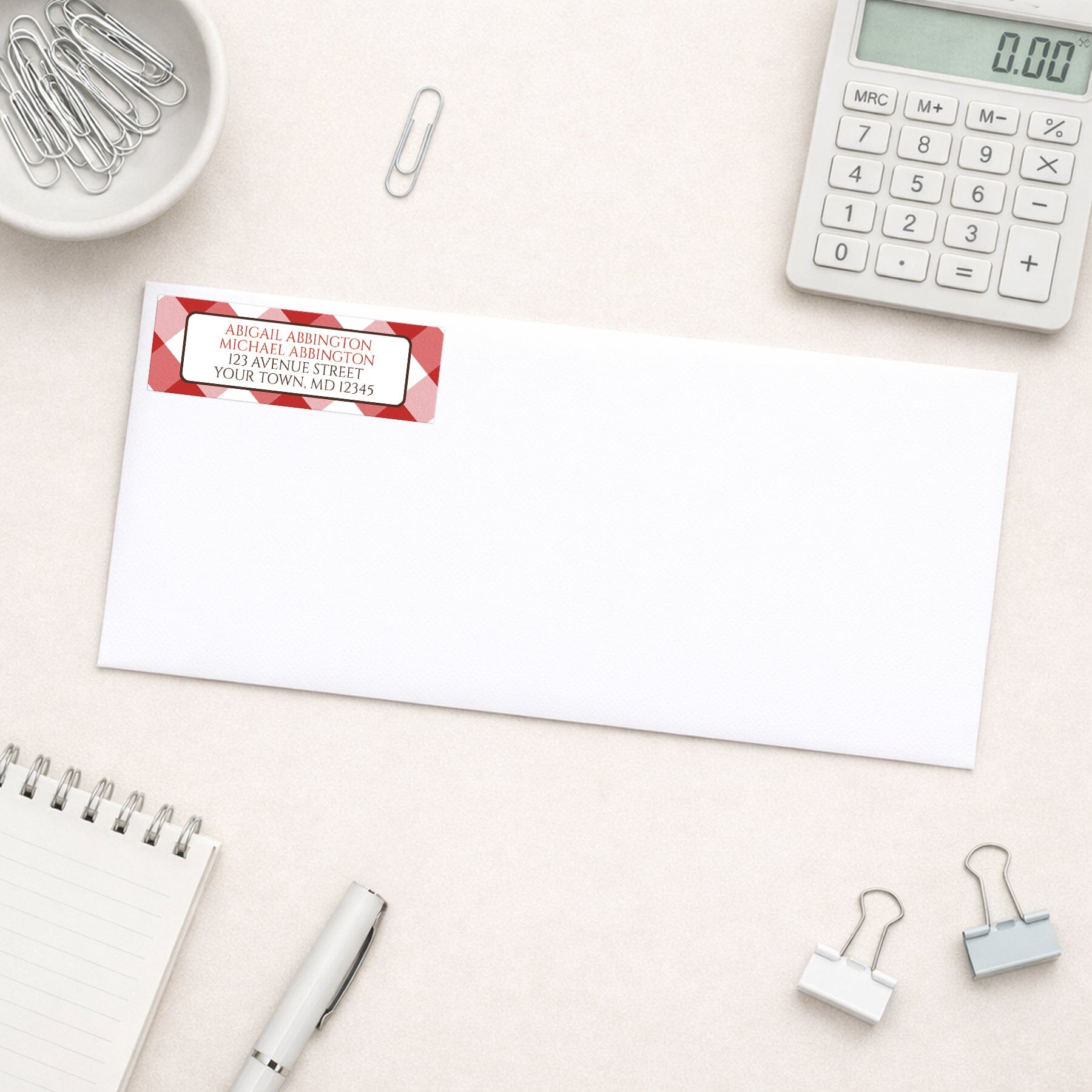Red Gingham Address Label shown on a white envelope with everyday office supplies