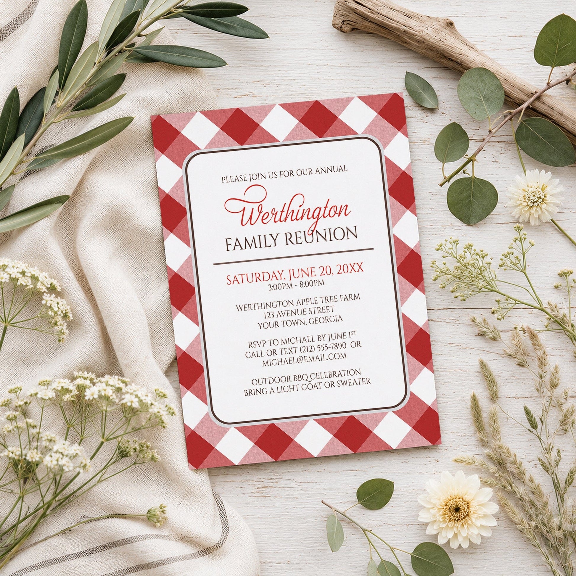 Red Gingham Family Reunion Invitation shown on a wooden surface with spring and summer plants.