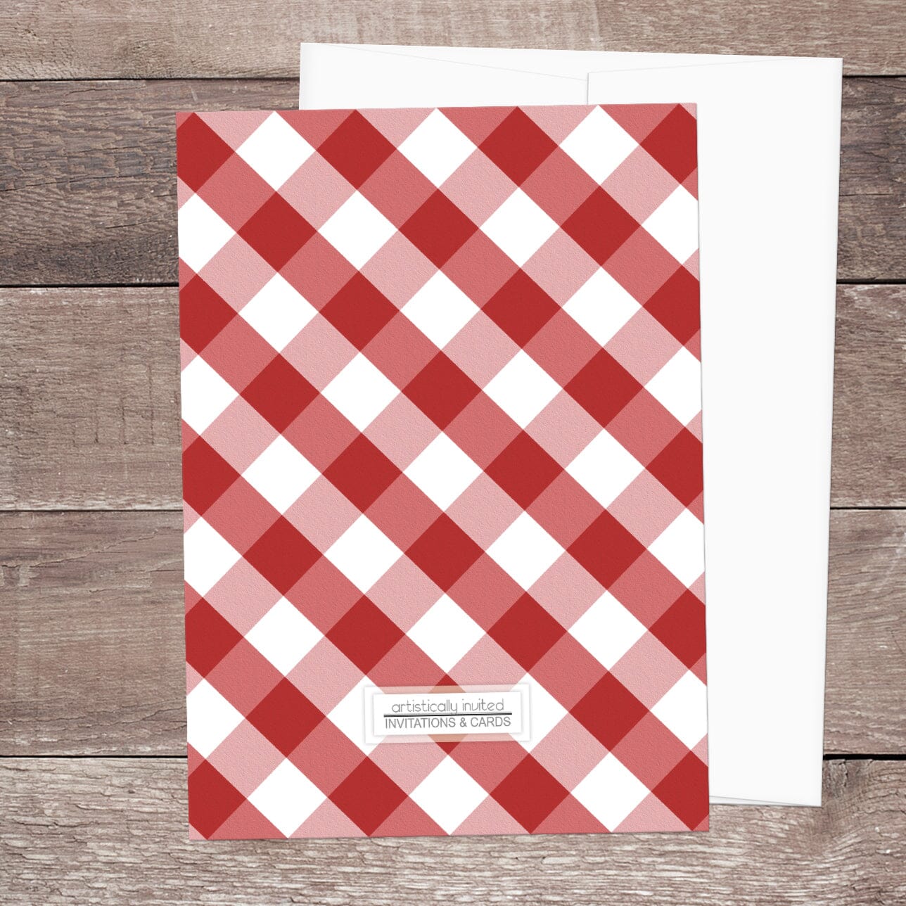 Back side of the Red Gingham Family Reunion Invitation, shown on a wooden surface with a white envelope.