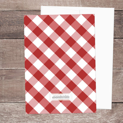 Back side of the Red Gingham Family Reunion Invitation, shown on a wooden surface with a white envelope.