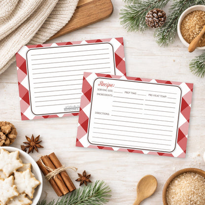 Two Red Gingham Recipe Cards on a wooden surface with winter and holiday decorations.