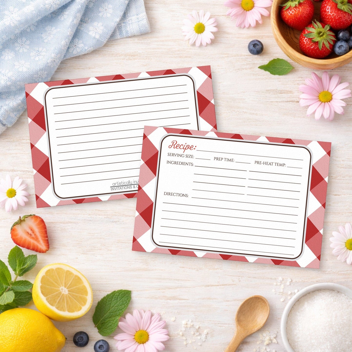 Two Red Gingham Recipe Cards on a wooden surface with spring and summer fruits and flowers.