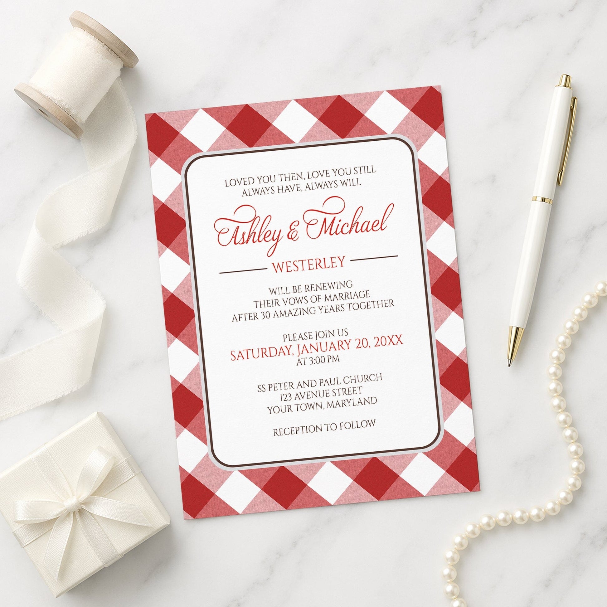 Red Gingham Vow Renewal Invitation shown on a marble surface with a white gift box, pen, ribbon, and pearls.