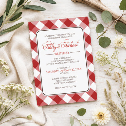 Red Gingham Vow Renewal Invitation shown on a light wooden surface with spring and summer plants.