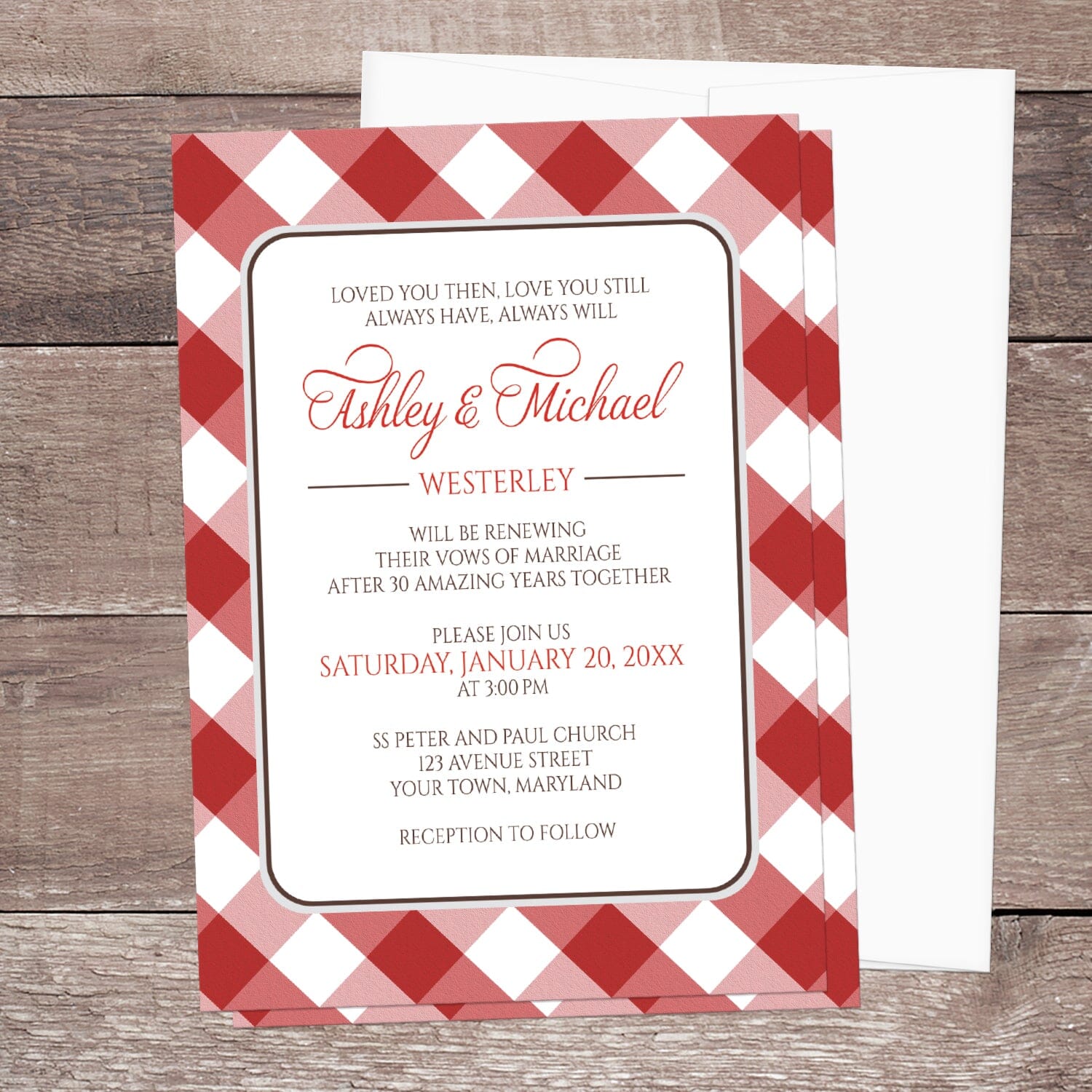 Red Gingham Vow Renewal Invitation shown on a brown wooden surface with a white envelope.