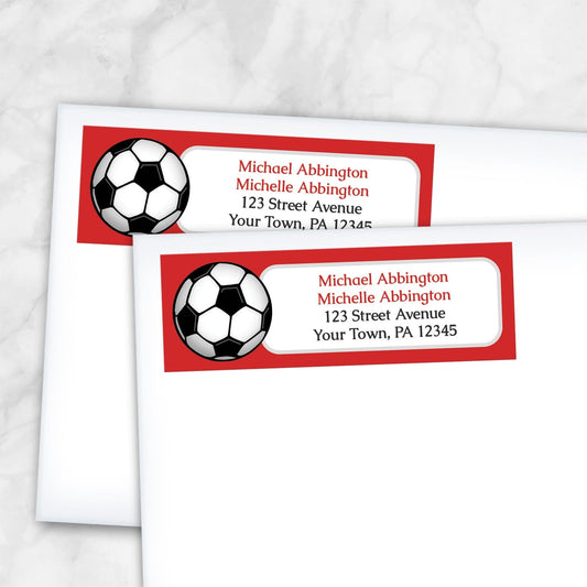 2 Red Soccer Ball Return Address Labels shown on white envelopes on a marble surface