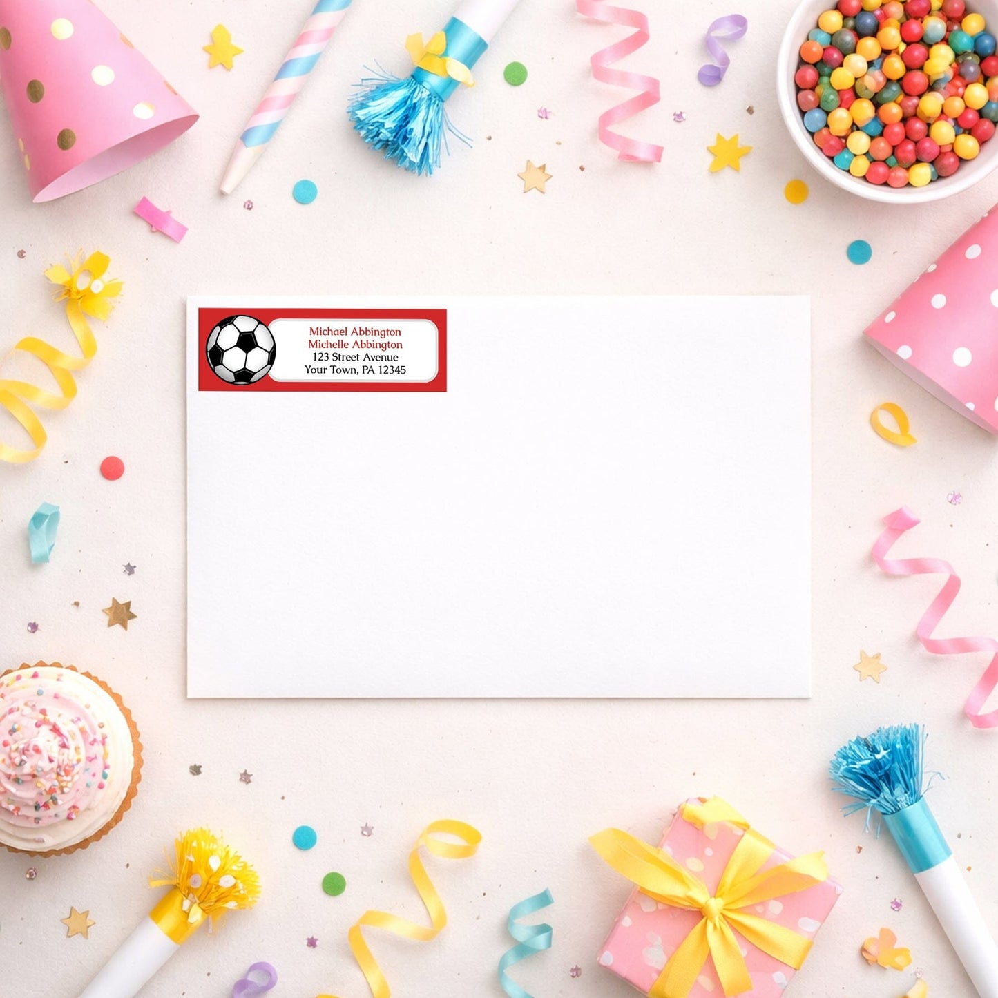 Red Soccer Ball Return Address Label shown on a white envelope with party supplies