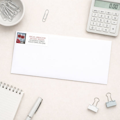 Red Wine Glasses Floral Rose Address Label shown on a white envelope with everyday office supplies
