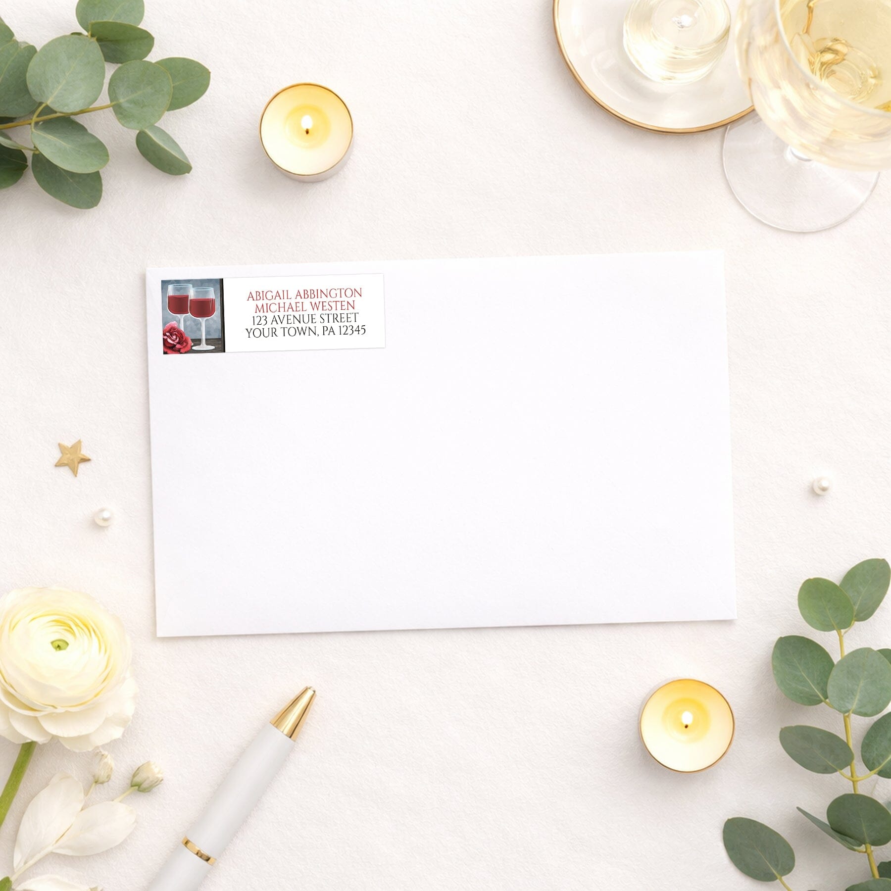 Red Wine Glasses Floral Rose Address Label shown on a white envelope with wedding and shower supplies