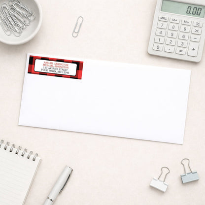 Red and Black Buffalo Plaid Address Label shown on a white envelope with everyday office supplies