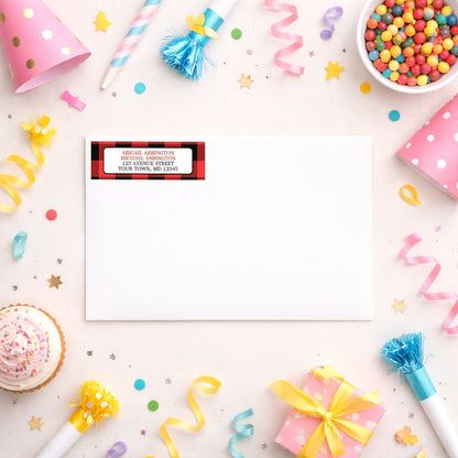 Red and Black Buffalo Plaid Address Label shown on a white envelope with party supplies