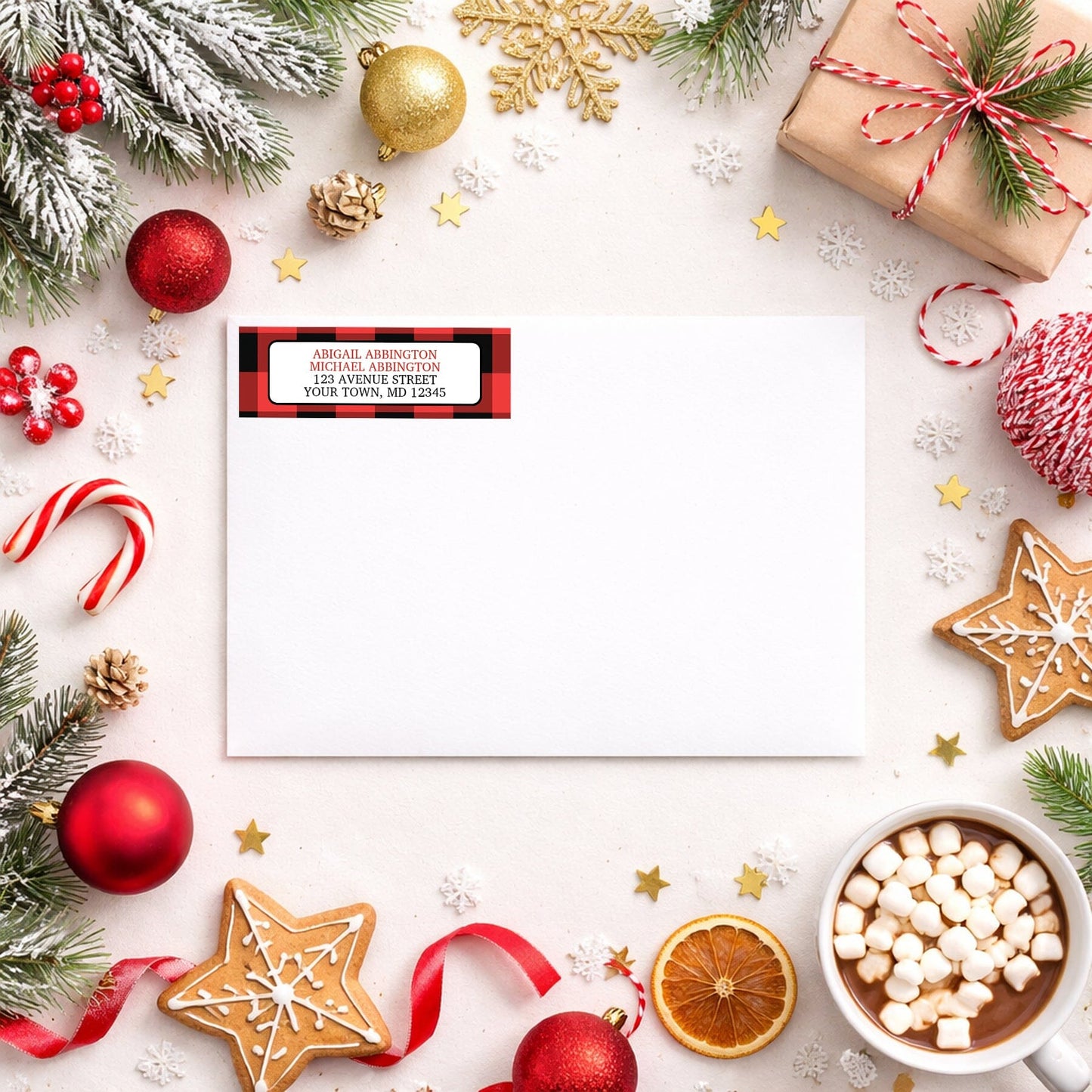 Red and Black Buffalo Plaid Address Label shown on a white envelope with winter Christmas holiday supplies