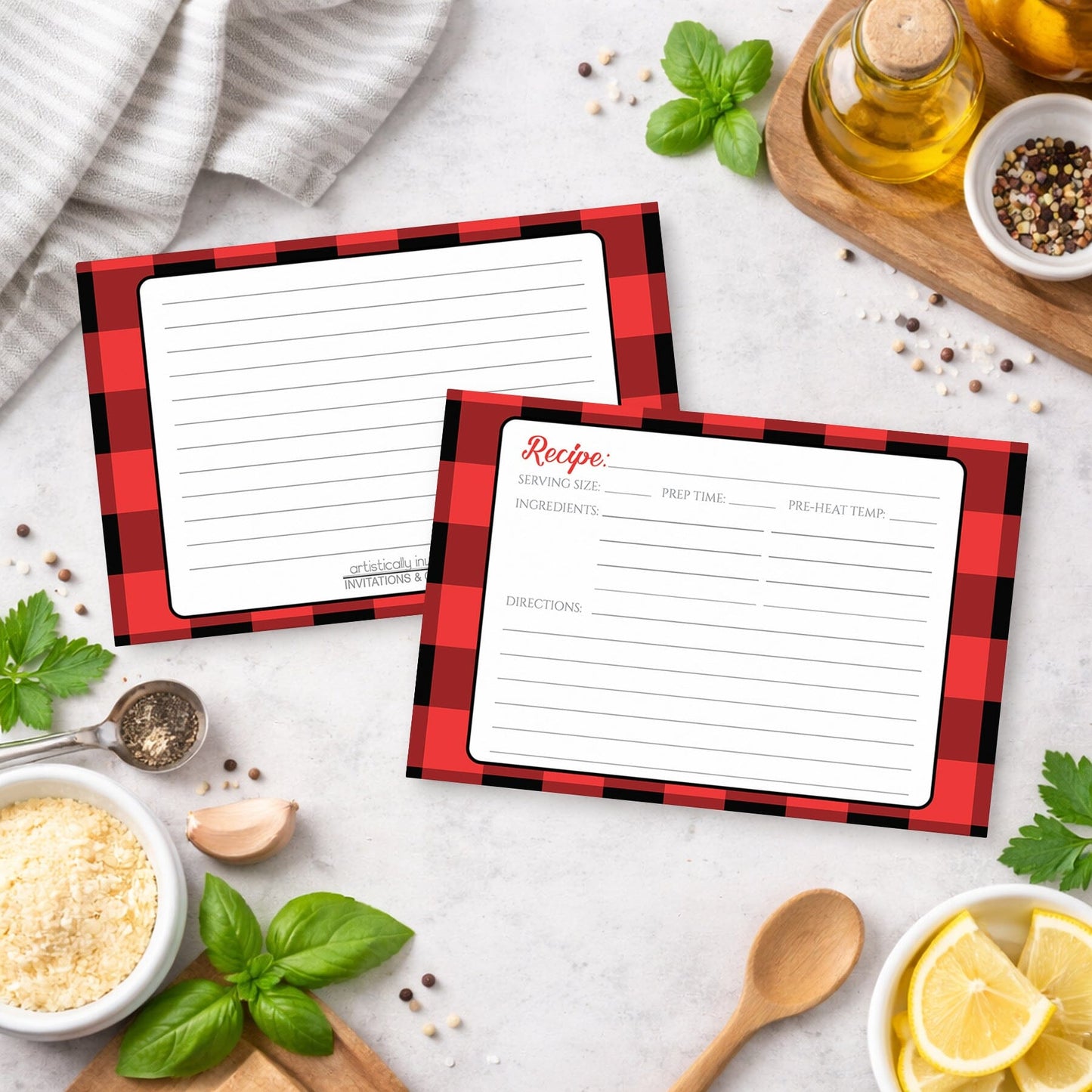Two Red and Black Buffalo Plaid Recipe Cards on a kitchen counter with ingredients.