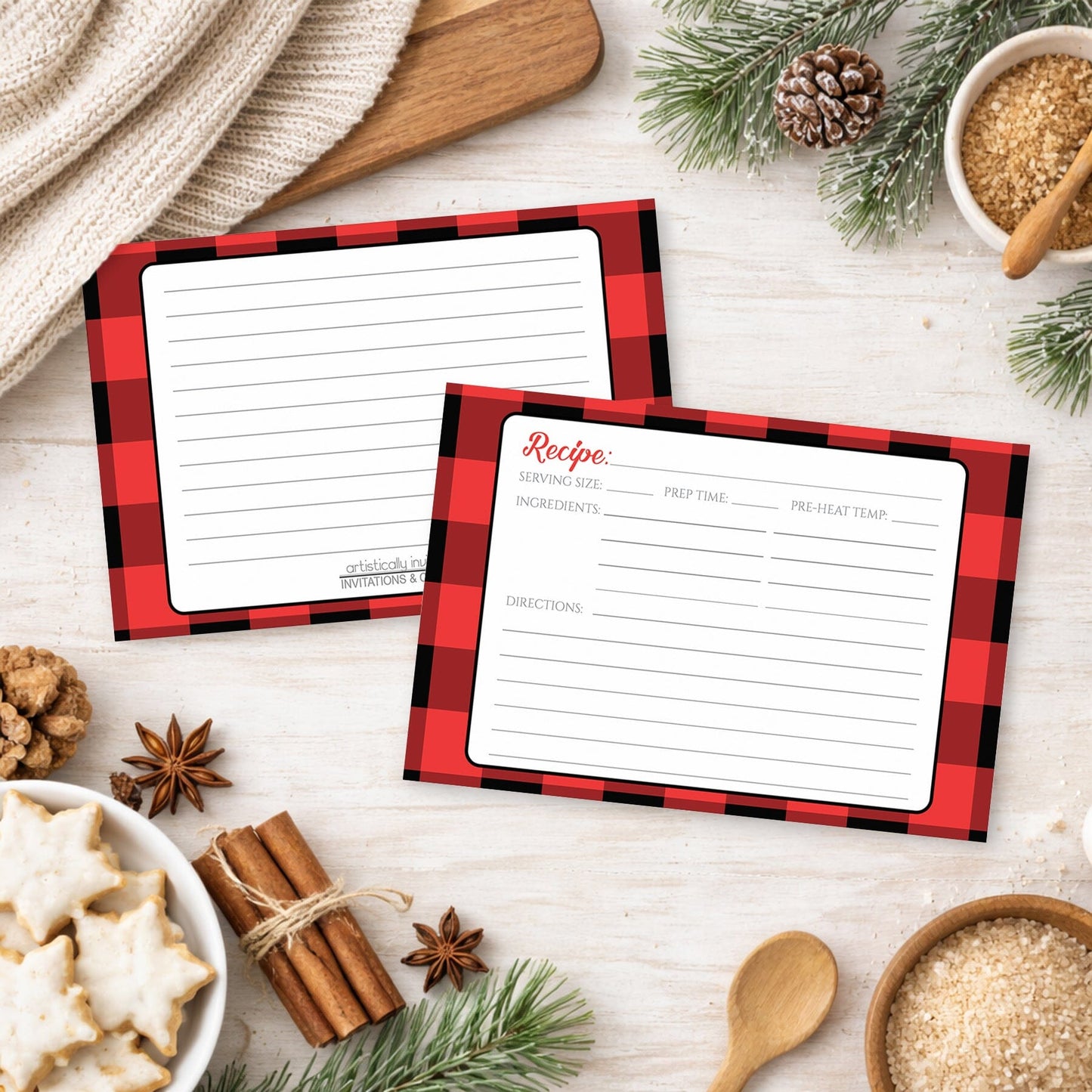 Two Red and Black Buffalo Plaid Recipe Cards on a festive wood countertop background with holiday cookies, cinnamon, and winter pine branches.