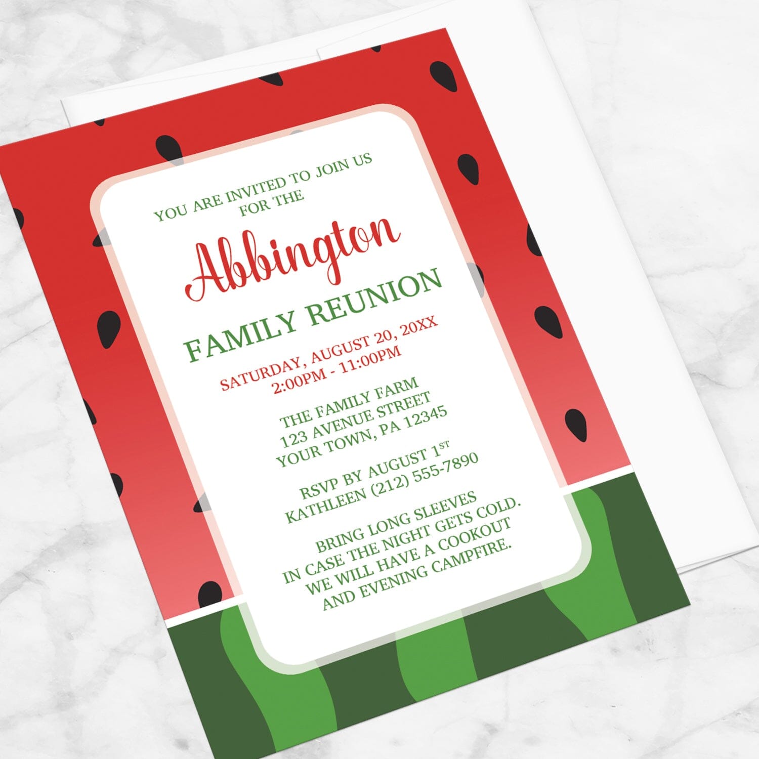 Red and Green Watermelon Family Reunion Invitation shown at an angle on a marble surface with a white envelope.