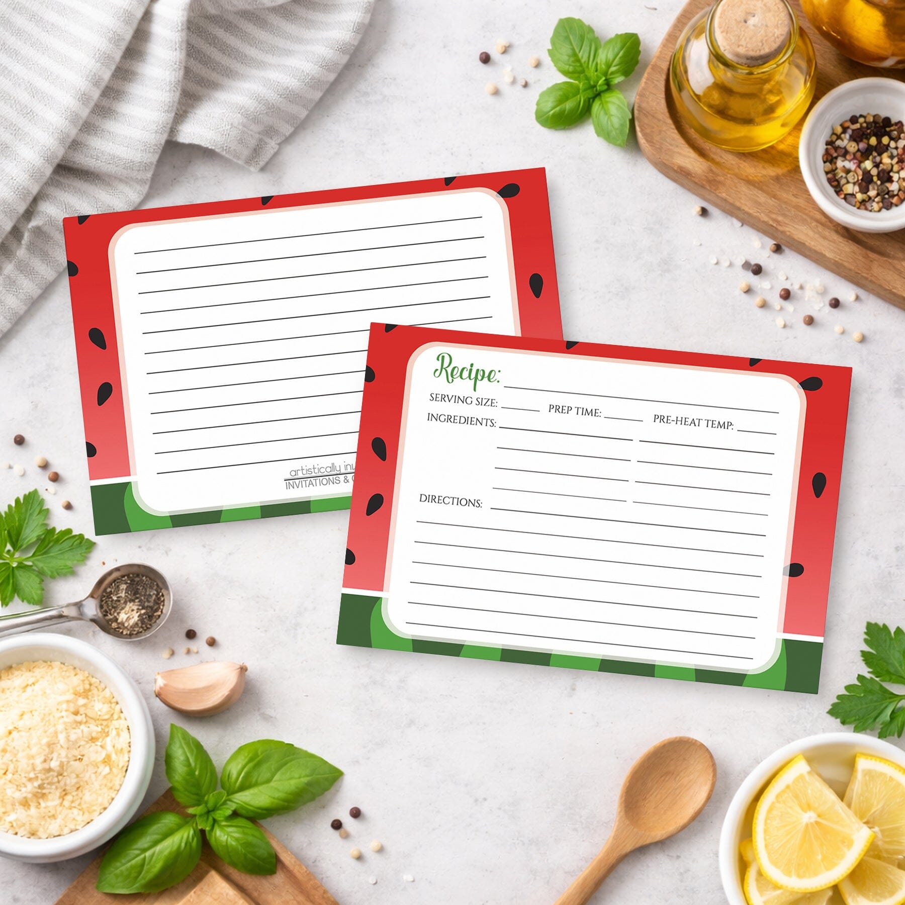 Two Red and Green Watermelon Recipe Cards on a kitchen counter with ingredients.