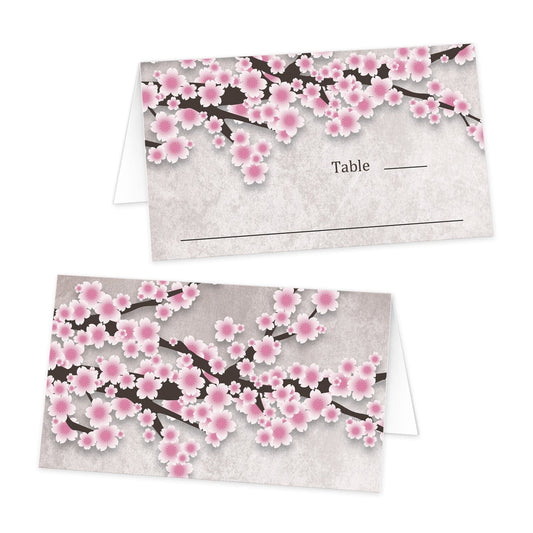 Rustic Pink Cherry Blossom Folded Place Cards at Artistically Invited. Beautiful rustic pink cherry blossom folded place cards designed with an illustration of pink cherry blossoms on dark brown branches over a stony grayish brown marble-like background on the outer folded sides. Your lines for writing the guest's name and table number are on one side of the folded cards below the pretty cherry blossoms. 