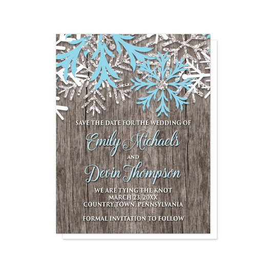 Rustic Winter Wood Blue Snowflake Save the Date Cards at Artistically Invited. Country-inspired rustic winter wood blue snowflake save the date cards designed with light blue, white, and silver-colored glitter-illustrated snowflakes along the top over a rustic wood pattern illustration. Your personalized wedding date details are custom printed in light blue and white over the wood background below the snowflakes.