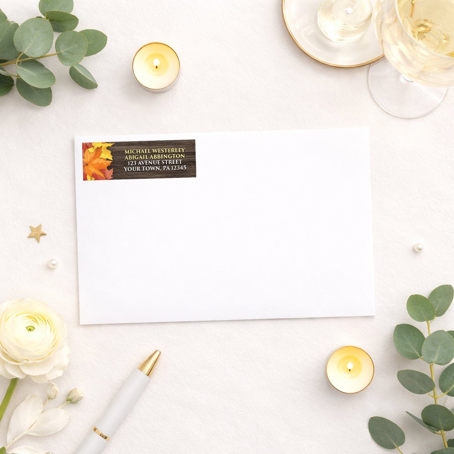 Rustic Autumn Leaves Wood Address Label shown on a white envelope with wedding supplies