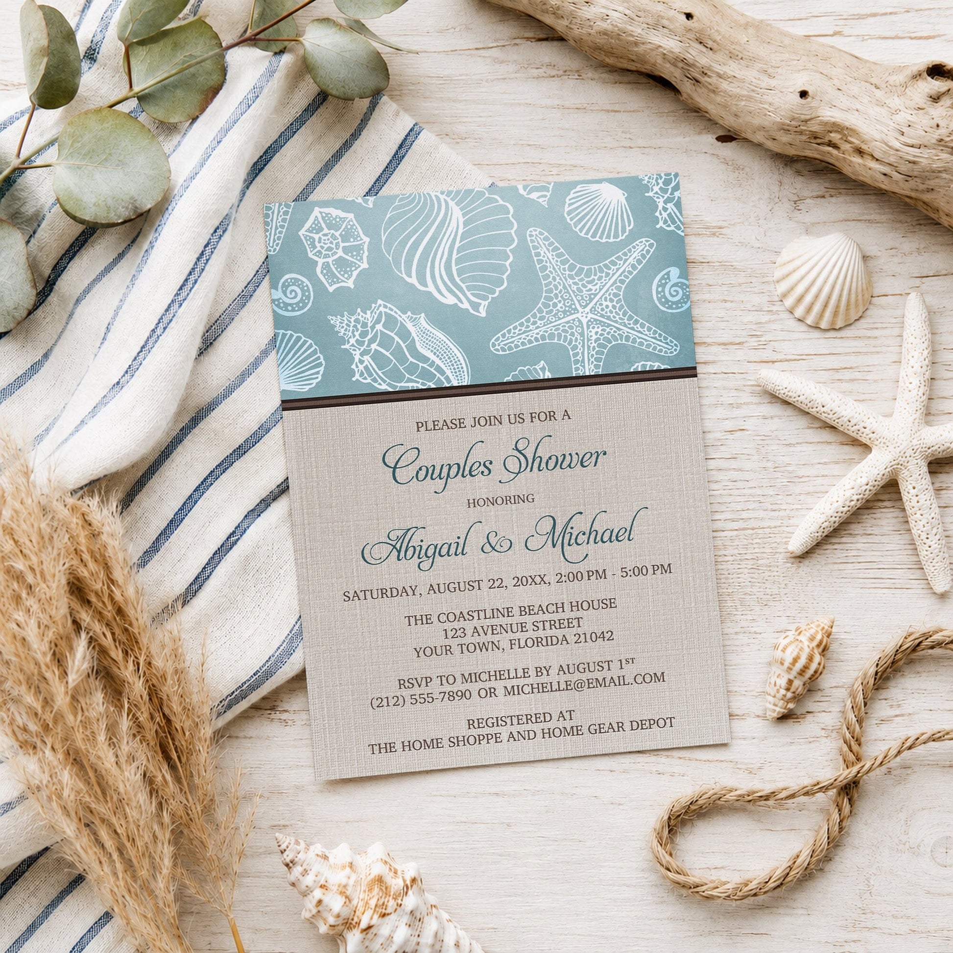 Rustic Beach Linen Seashell Couples Shower Invitation shown on a light wooden surface with seashells and coastal decor.