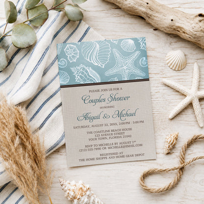 Rustic Beach Linen Seashell Couples Shower Invitation shown on a light wooden surface with seashells and coastal decor.