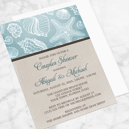 Rustic Beach Linen Seashell Couples Shower Invitation shown at an angle on a marble surface with a white envelope.