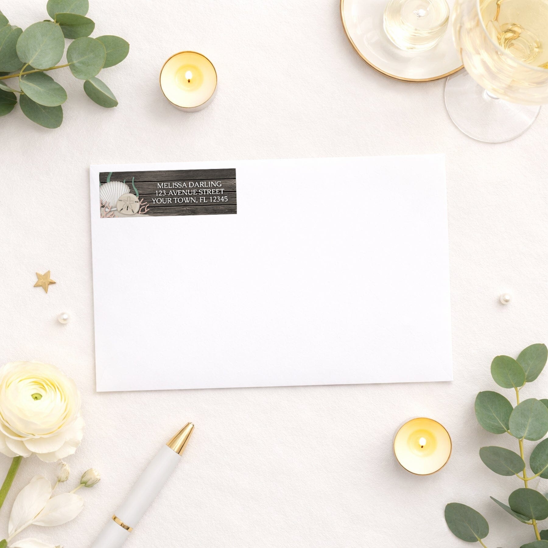 Rustic Beach Seashells and Wood Address Label shown on a white envelope with wedding and shower supplies