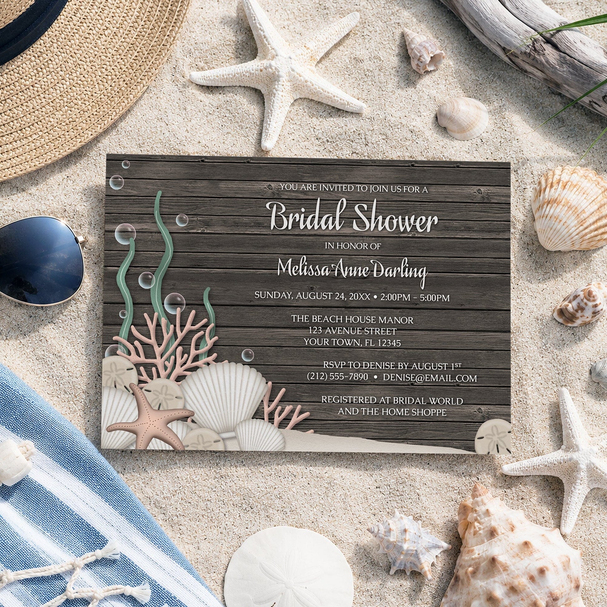 Rustic Beach Seashells and Wood Bridal Shower Invitation on sand with seashells and other beach accessories.