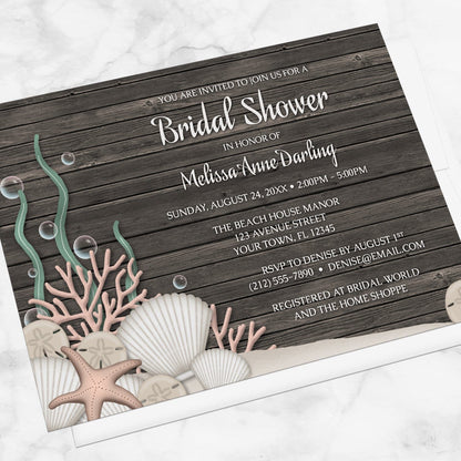 Rustic Beach Seashells and Wood Bridal Shower Invitation shown at an angle on a marble surface
