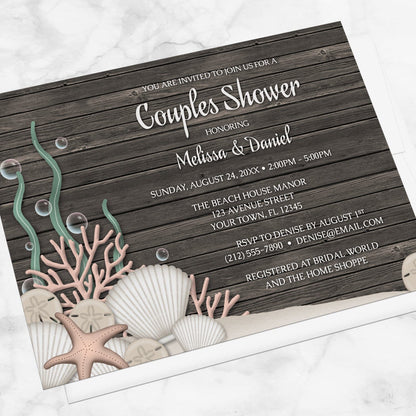 Rustic Beach Seashells and Wood Couples Shower Invitation shown at an angle on a marble surface with a white envelope.