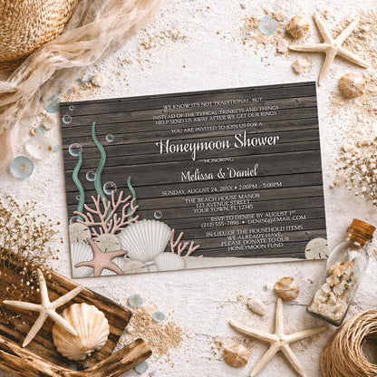 Rustic Beach Seashells and Wood Honeymoon Shower Invitation shown on a light surface with seashells, beach sand, and coastal decor.