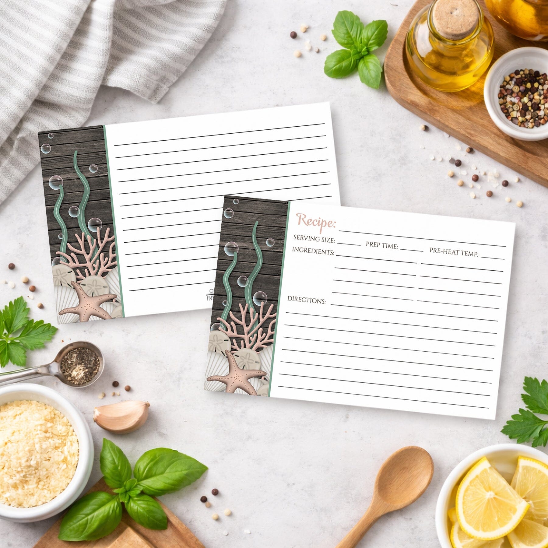Set of Rustic Beach Seashells and Wood Recipe Cards with ocean-themed design on a kitchen counter with ingredients and utensils.