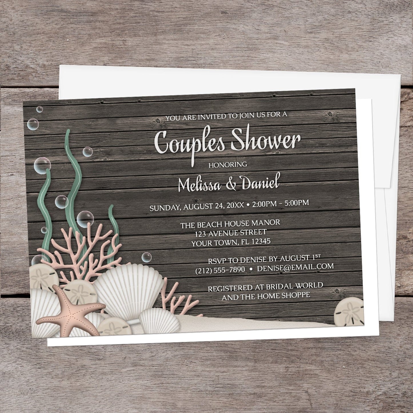 Rustic Beach Seashells and Wood Couples Shower Invitation shown on a brown wood surface with a white envelope.