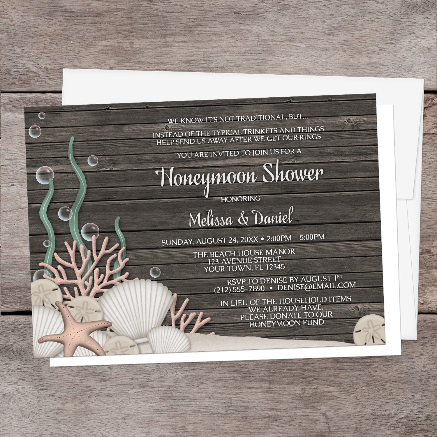 Rustic Beach Seashells and Wood Honeymoon Shower Invitation shown on a brown wood surface with a white envelope.
