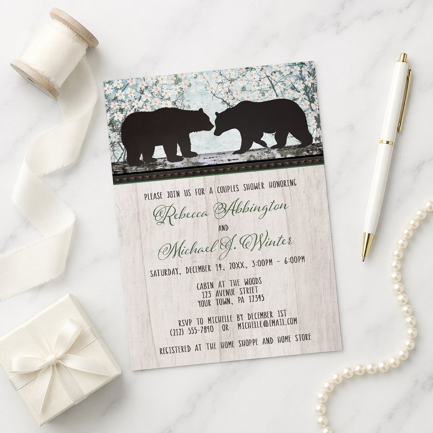 Rustic Bear Floral Wood Couples Shower Invitation shown on a marble surface with a white gift box, pen, ribbon, and pearls.