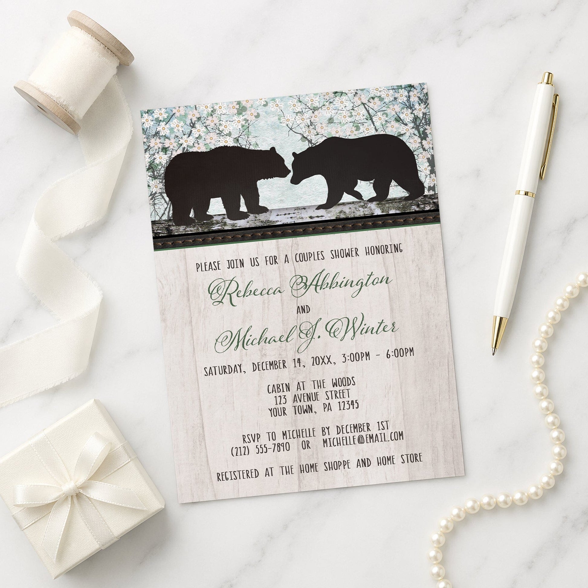 Rustic Bear Floral Wood Couples Shower Invitation shown on a marble surface with a white gift box, pen, ribbon, and pearls.